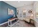 Bright home office with large windows, accent wall, and desk, creating an ideal workspace at 2924 Tranquility Rd, Mount Pleasant, SC 29466