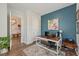 Home office with a striking blue accent wall, modern desk, and a comfortable chair at 2924 Tranquility Rd, Mount Pleasant, SC 29466