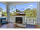 Cozy covered patio with a fireplace, TV, comfortable seating, and a scenic outdoor view at 2924 Tranquility Rd, Mount Pleasant, SC 29466