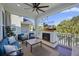 Inviting covered patio featuring comfortable seating, a ceiling fan, and a cozy fireplace with TV at 2924 Tranquility Rd, Mount Pleasant, SC 29466