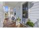 Charming porch featuring cozy rocking chairs, lush greenery, and a welcoming entrance at 2924 Tranquility Rd, Mount Pleasant, SC 29466