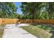 Spacious backyard with a concrete patio, wood fence, and green grass; perfect for outdoor entertaining at 2957 Alabama Dr, North Charleston, SC 29405