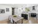 Modern kitchen boasts stainless steel appliances, white cabinets, and a breakfast bar with stool seating at 2957 Alabama Dr, North Charleston, SC 29405