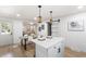 Open-concept kitchen and living room with modern furnishings, stylish decor, and hardwood floors at 2957 Alabama Dr, North Charleston, SC 29405