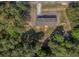 Overhead view of single-story home nestled in a vibrant green forest, showing the roof and surrounding landscape at 314 Hickory Nut Way, Cross, SC 29436