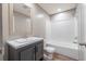 Full bathroom with single vanity, laminate floors, tub with white enclosure, and modern fixtures at 314 Hickory Nut Way, Cross, SC 29436