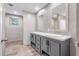 Bright bathroom features double sinks with gray cabinets, two mirrors, and wood look floors at 314 Hickory Nut Way, Cross, SC 29436