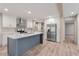 Contemporary kitchen featuring stainless steel refrigerator, white cabinets, a central island, and modern appliances at 314 Hickory Nut Way, Cross, SC 29436