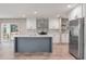 Modern kitchen features white cabinets, stainless steel appliances, a blue island, and views of the backyard at 314 Hickory Nut Way, Cross, SC 29436