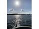 Scenic lake view with glistening water and clear skies, perfect for relaxation and recreation at 314 Hickory Nut Way, Cross, SC 29436