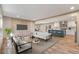 Bright open-concept living area featuring modern furnishings and a view into the adjacent kitchen and dining area at 314 Hickory Nut Way, Cross, SC 29436
