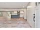 Open-concept living space with modern flooring, a kitchen island, and plenty of natural light from sliding glass door at 314 Hickory Nut Way, Cross, SC 29436
