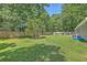 Well-maintained backyard featuring a lush lawn, mature trees, and a wooden privacy fence at 333 Price St, Goose Creek, SC 29445