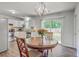 Charming dining area with stainless steel appliances, stylish chandelier, and sliding door to the backyard at 333 Price St, Goose Creek, SC 29445