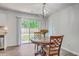 Cozy dining area features a round table, elegant chandelier, and sliding glass doors offering backyard views at 333 Price St, Goose Creek, SC 29445