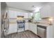 Bright kitchen features white cabinets, stainless steel appliances, and durable, attractive wood-look flooring at 333 Price St, Goose Creek, SC 29445