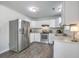 A full view of the spacious kitchen, including stainless steel appliances, stylish white cabinets and wood flooring at 333 Price St, Goose Creek, SC 29445
