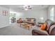Spacious living area with plush seating and open layout, seamlessly connecting to the dining area and kitchen beyond at 333 Price St, Goose Creek, SC 29445