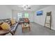 Comfortable living room featuring leather sofas, ceiling fan, large TV, and neutral-toned walls and carpeting at 333 Price St, Goose Creek, SC 29445