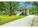 Charming two-story home with a welcoming front porch and mature trees in a lush, green lawn at 3635 Pandora Dr, Mount Pleasant, SC 29466
