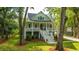 Charming two-story home with a welcoming front porch and well-manicured lawn surrounded by mature trees at 3635 Pandora Dr, Mount Pleasant, SC 29466