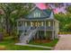 Beautiful two-story home featuring a spacious porch, lush greenery, and inviting curb appeal at 3635 Pandora Dr, Mount Pleasant, SC 29466