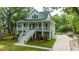 Elegant two-story home with a covered porch, a well maintained lawn and lush landscaping at 3635 Pandora Dr, Mount Pleasant, SC 29466