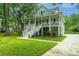 Charming two-story home with a spacious porch, lush landscaping, and a welcoming curb appeal at 3635 Pandora Dr, Mount Pleasant, SC 29466
