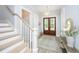 Inviting foyer featuring a staircase, wood floors, a stylish rug, and an elegant light fixture at 3635 Pandora Dr, Mount Pleasant, SC 29466