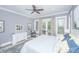 A bright main bedroom features floral drapes, a ceiling fan, and access to a private balcony at 3635 Pandora Dr, Mount Pleasant, SC 29466