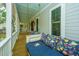 Relaxing porch swing with decorative pillows, providing a comfortable outdoor retreat at 3635 Pandora Dr, Mount Pleasant, SC 29466