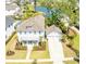 Stunning aerial view of a bright white home with a detached garage and backyard pond at 3688 Goodwater St, Mount Pleasant, SC 29466
