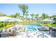 Inviting backyard pool area with lounge chairs, umbrellas, and a view of the lake and playground at 3688 Goodwater St, Mount Pleasant, SC 29466