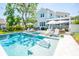 Stunning backyard oasis with a sparkling pool, lounge chairs, and outdoor dining area at 3688 Goodwater St, Mount Pleasant, SC 29466
