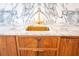 Detailed view of the golden sink and wooden cabinets of the custom bar, complemented by a marble countertop at 3688 Goodwater St, Mount Pleasant, SC 29466