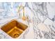 Close-up of the wet bar area, highlighting the golden sink and faucet on a marble countertop at 3688 Goodwater St, Mount Pleasant, SC 29466