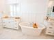 Bright bathroom featuring a soaking tub, white marble floors, double vanities and modern fixtures at 3688 Goodwater St, Mount Pleasant, SC 29466
