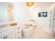 Bright bathroom featuring double vanities, soaking tub, white marble floors and modern fixtures at 3688 Goodwater St, Mount Pleasant, SC 29466