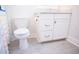 Bright bathroom features a white vanity with gold hardware, toilet, and neutral tile flooring at 3688 Goodwater St, Mount Pleasant, SC 29466