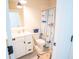 Well-lit bathroom with white vanity, tile flooring, and fun shark-themed shower curtain at 3688 Goodwater St, Mount Pleasant, SC 29466
