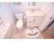 Bright bathroom featuring a white vanity with marble countertop and a cute 'Rise & Sunshine' rug at 3688 Goodwater St, Mount Pleasant, SC 29466