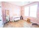 Bedroom with stylish pink and white geometric wallpaper, vanity, mirror, and bright window at 3688 Goodwater St, Mount Pleasant, SC 29466