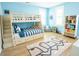 ' bedroom featuring a bunk bed with stairs, a playful rug, and bright blue accent wall at 3688 Goodwater St, Mount Pleasant, SC 29466