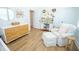 Bright Bedroom with hardwood floors, a cozy armchair, and a stylish wood and white dresser at 3688 Goodwater St, Mount Pleasant, SC 29466