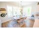 Bright dining room features modern lighting, large windows, and seating for eight at 3688 Goodwater St, Mount Pleasant, SC 29466