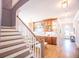 Grand entry staircase leading to a living area with a bar and dining table at 3688 Goodwater St, Mount Pleasant, SC 29466
