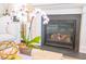 Close up of fireplace with beautiful mantle, decor, and orchid at 3688 Goodwater St, Mount Pleasant, SC 29466
