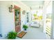 Cozy front porch featuring a porch swing, ferns, and a decorative welcome mat at 3688 Goodwater St, Mount Pleasant, SC 29466