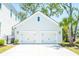 Spacious two-car garage with white doors and modern lighting fixtures enhancing curb appeal at 3688 Goodwater St, Mount Pleasant, SC 29466
