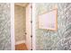 Hallway featuring a door and decorative leafy green wallpaper at 3688 Goodwater St, Mount Pleasant, SC 29466